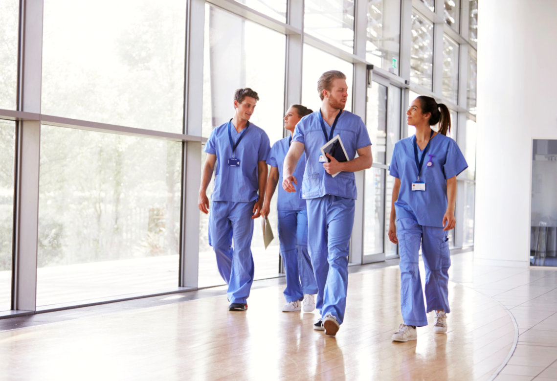 four medical workers walking